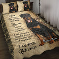 Rottweiler quilt blanket displayed on a bed with tan distressed artwork, ornate borders, and black-and-rust dog portraits