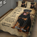 Close bedroom view of a Rottweiler quilt blanket featuring large black-and-rust dog artwork and tan decorative borders