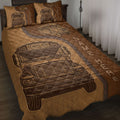 School bus driver quilt blanket spread across a bed with vintage bus artwork in warm brown tones