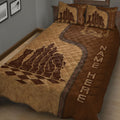 Close bedroom view of brown chess quilt bedding with king, queen, knight, and checkerboard artwork