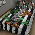 Irish shamrock and Celtic cross quilt blanket presented on a bed with black and white striped artwork