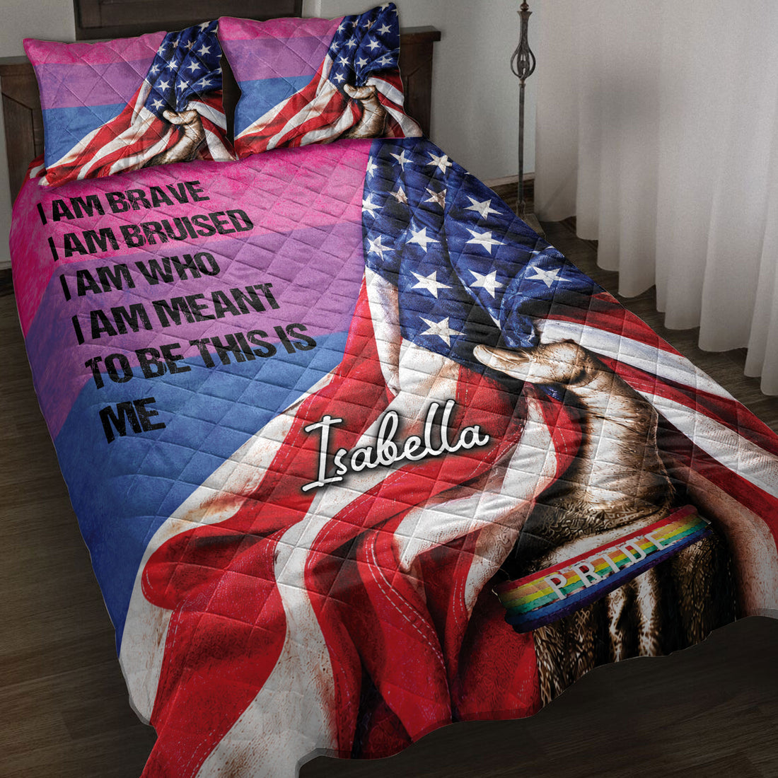 LGBT pride quilt blanket displayed on a bed with rainbow colors, stars, raised fist artwork, and pride band