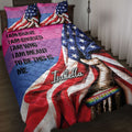 LGBT pride quilt blanket displayed on a bed with rainbow colors, stars, raised fist artwork, and pride band