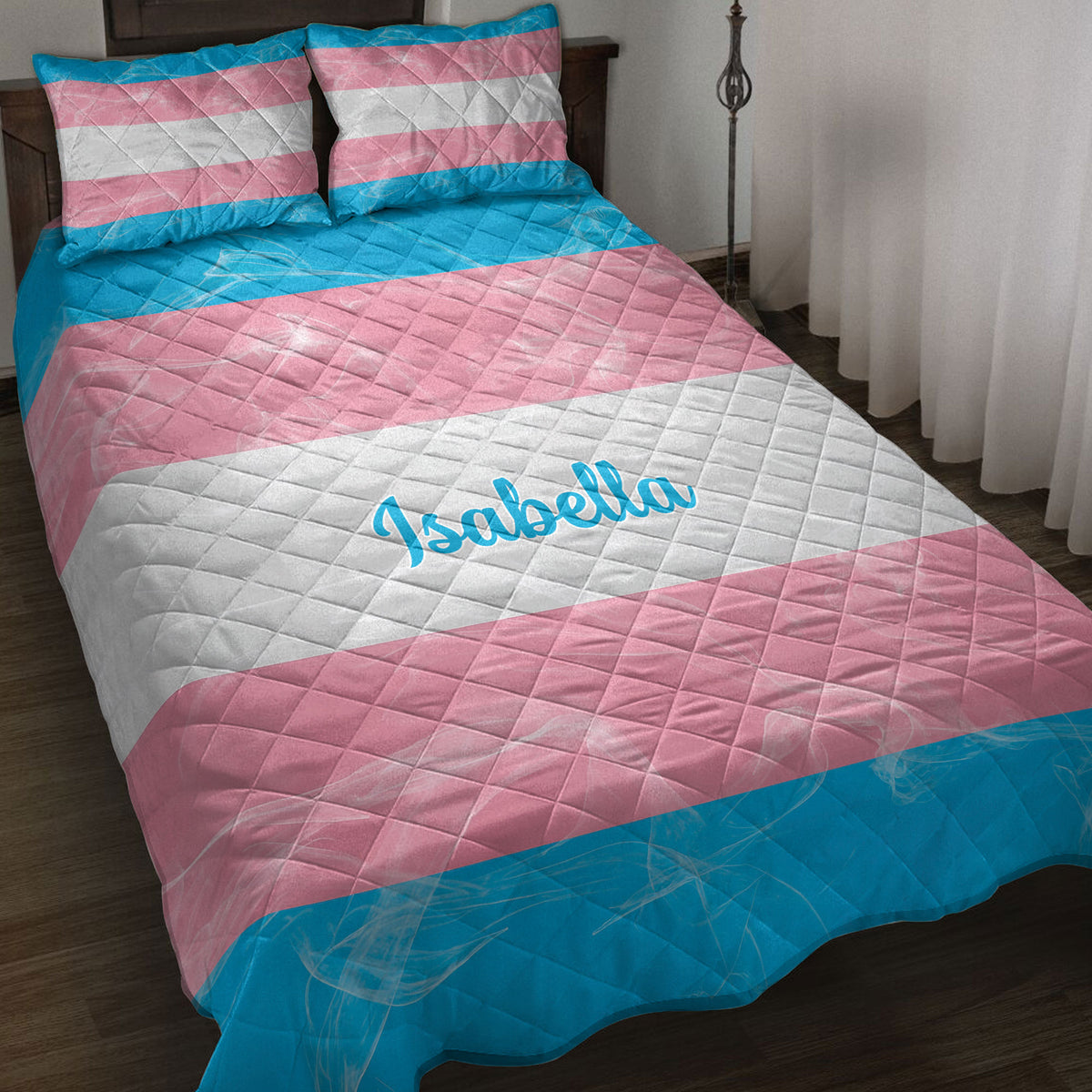 Transgender pride flag quilt blanket displayed on a bed with coordinating striped pillowcases