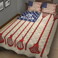 Close bedroom view of a lacrosse quilt blanket with red sticks and blue patterned sports artwork