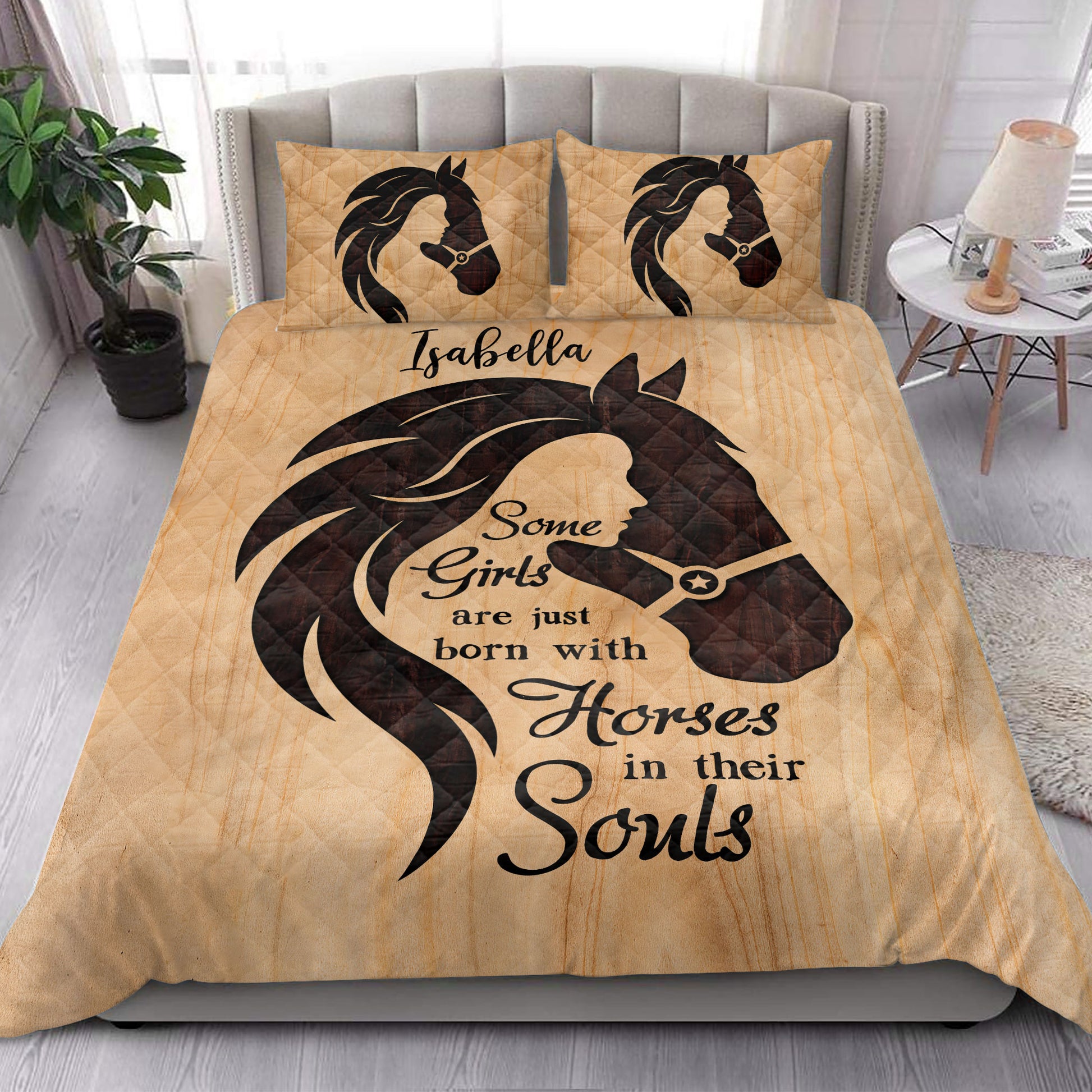 Horse-themed quilt blanket displayed in a bright bedroom with equestrian artwork and matching pillows