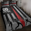 Baseball quilt blanket displayed on a bed with black, red, and gray stripes, baseball graphics, and player silhouettes