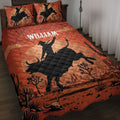 Rodeo quilt blanket on a bed with bull rider silhouettes, western desert scenery, cacti, and warm rust tones