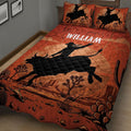Close view of a rodeo quilt blanket featuring a bull rider silhouette, desert landscape, cacti, and western artwork