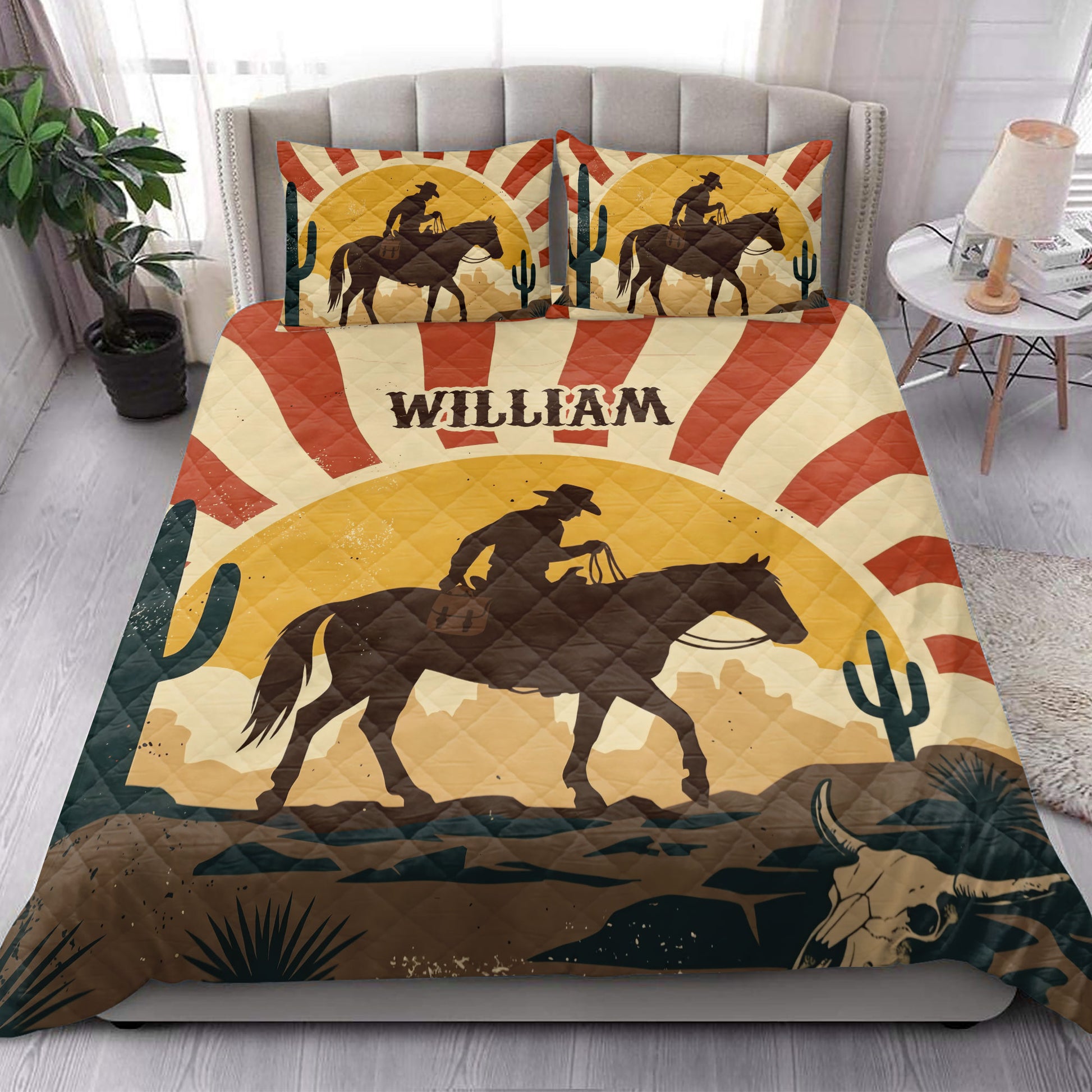 Western rodeo quilt styled in a bedroom with a large cowboy on horseback, cacti, and warm desert artwork