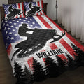 Snowmobile quilt bedding set displayed on a bed with patriotic stars, stripes, trees, and rider artwork
