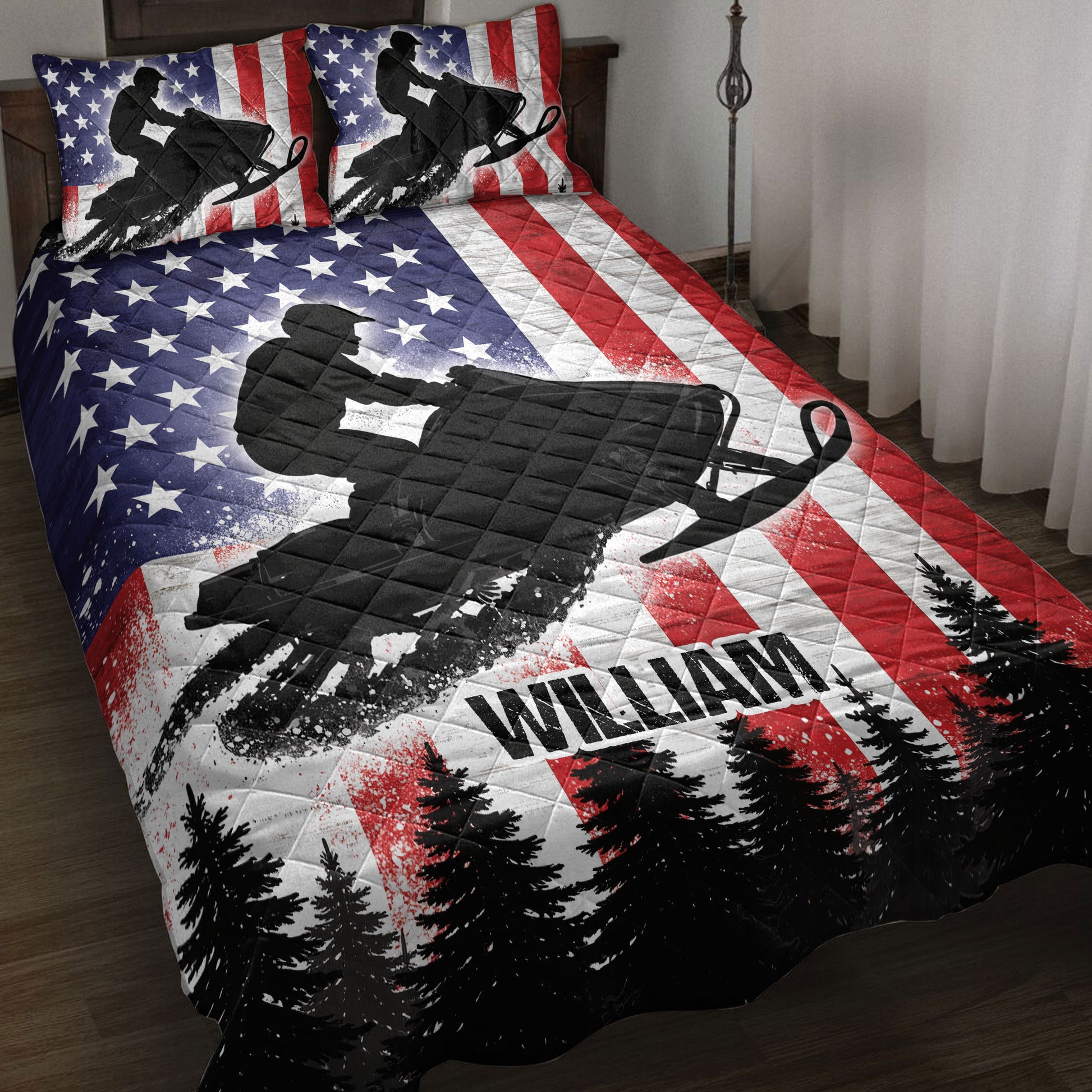 Snowmobile quilt bedding set displayed on a bed with patriotic stars, stripes, trees, and rider artwork