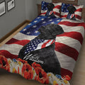 Black Labrador Retriever quilt blanket spread across a bed with stars, stripes, and floral accents