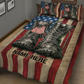 Patriotic military boots quilt blanket styled on a bedroom bed with matching bedding accents