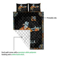 Softball quilt detail showing the printed front, quilted backing, and colorful batter artwork