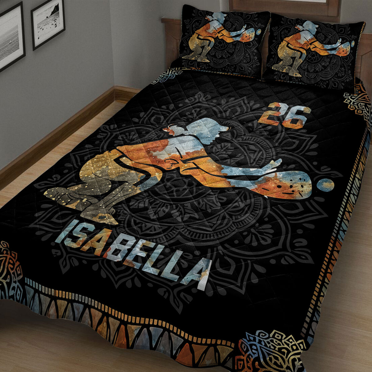 Close bedroom view of a black softball quilt blanket with vintage batter artwork and ornamental borders