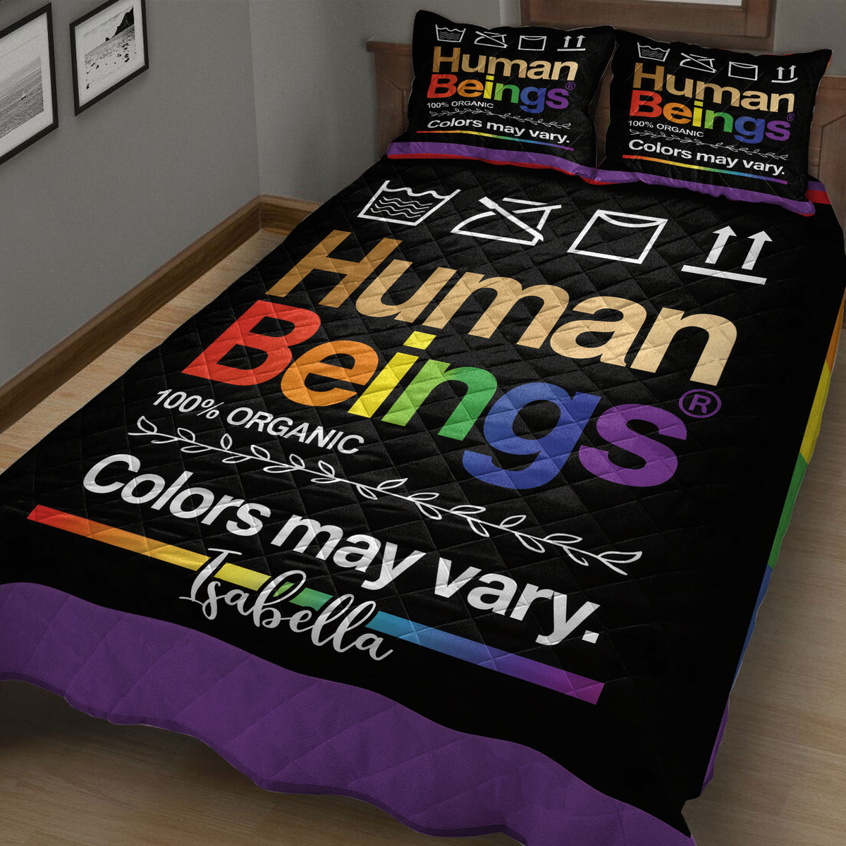Close angled view of black LGBT quilt blanket with vivid rainbow lettering and border
