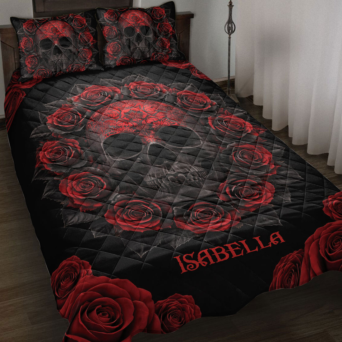 Black skull quilt blanket with ornate red roses displayed across a bedroom with matching pillows