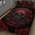 Close view of a black skull quilt blanket with dramatic red roses and matching skull pillows