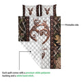 Close view of hunting quilt showing deer artwork, woodland border, white quilted backing, and printed front side