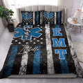 Paramedic quilt blanket styled in a bright bedroom with blue medical symbols and bold black, white, and blue stripes