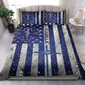 Paramedic quilt bedding set styled on a modern bed with navy medical star artwork and silver striped accents