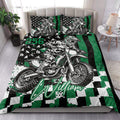 Motocross quilt bedding styled in a bright bedroom with dirt bike rider artwork and green accents