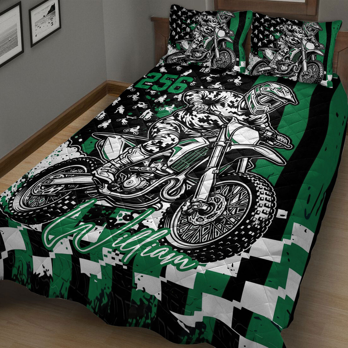 Close bedroom view of a black and green motocross quilt with dirt bike and rider artwork