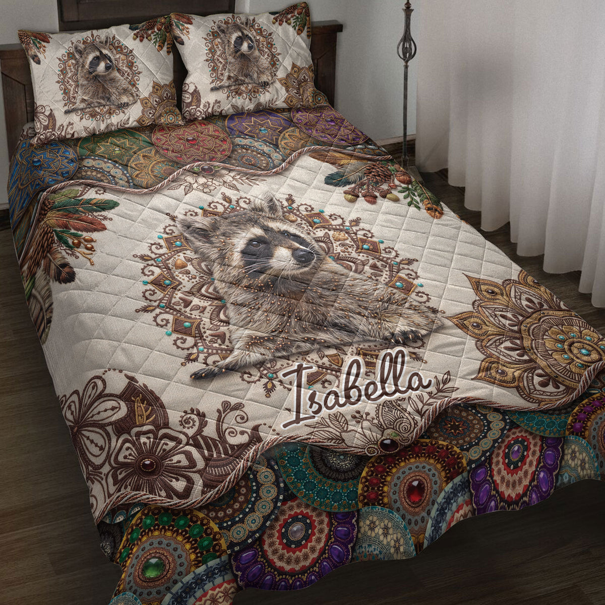 Raccoon quilt blanket styled on a bed with ornate mandala patterns, feathers, and colorful woodland artwork