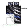 Police quilt blanket detail showing the printed flag design and white quilted backing