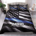 Police quilt bedding set styled on a bedroom bed with stars, stripes, and thin blue line artwork