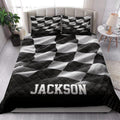 Black and white racing quilt blanket styled across a modern bedroom with matching patterned pillows