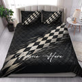 Checkered flag racing quilt blanket styled across a modern bedroom with matching bedding