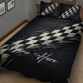 Close bedroom view of black racing quilt blanket with dynamic checkered flag graphics