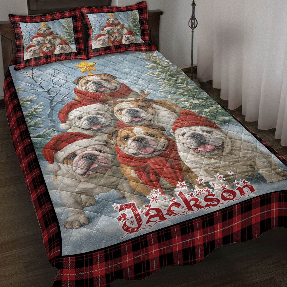 English Bulldog Christmas quilt blanket styled on a bed with red plaid borders, snowy trees, and festive bulldog artwork