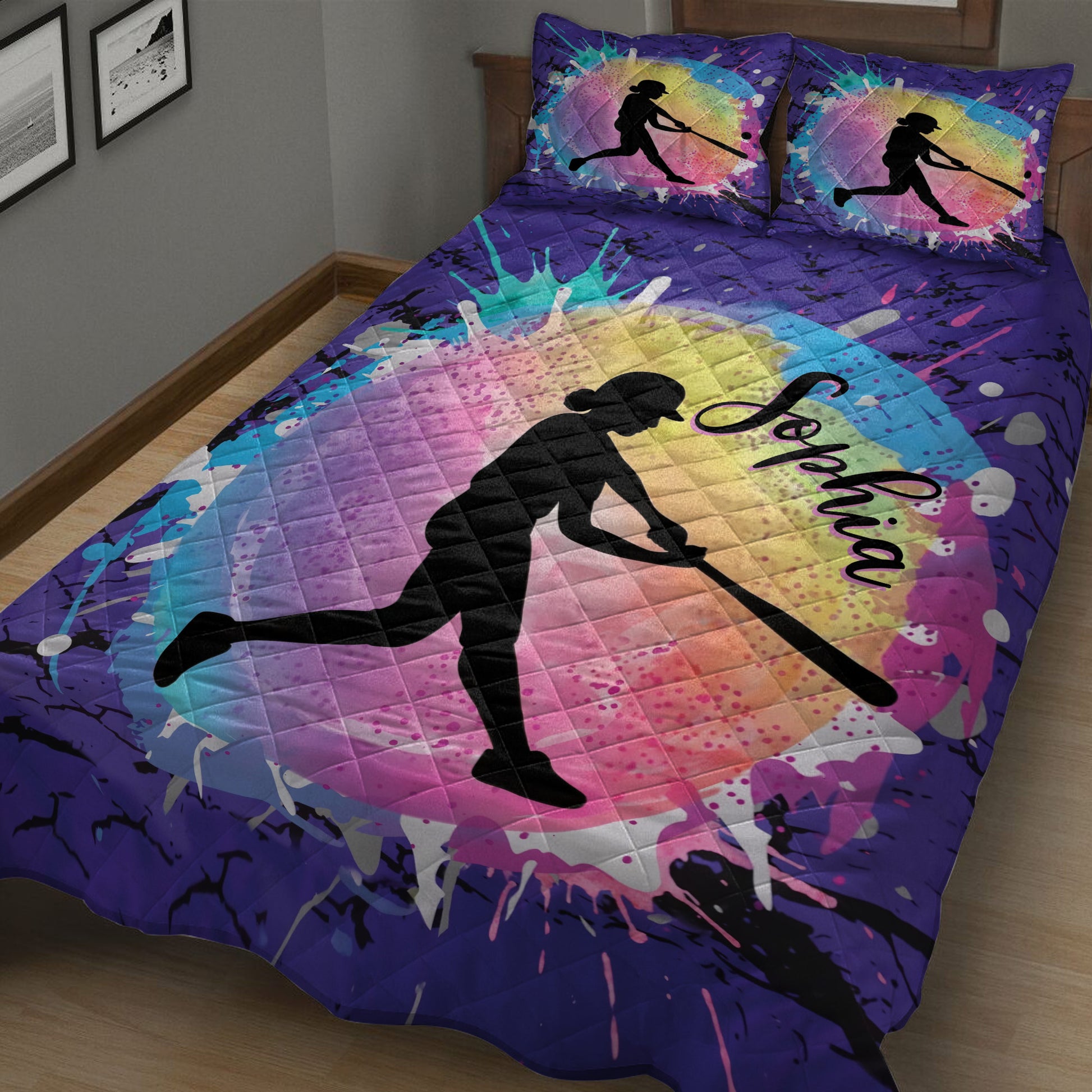 Close-up view of purple softball quilt blanket with vibrant rainbow artwork and female batter silhouette