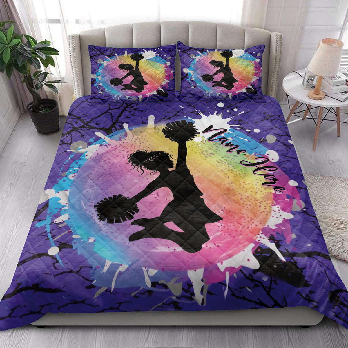 Cheerleading quilt blanket styled in a bright bedroom with colorful pom-pom artwork