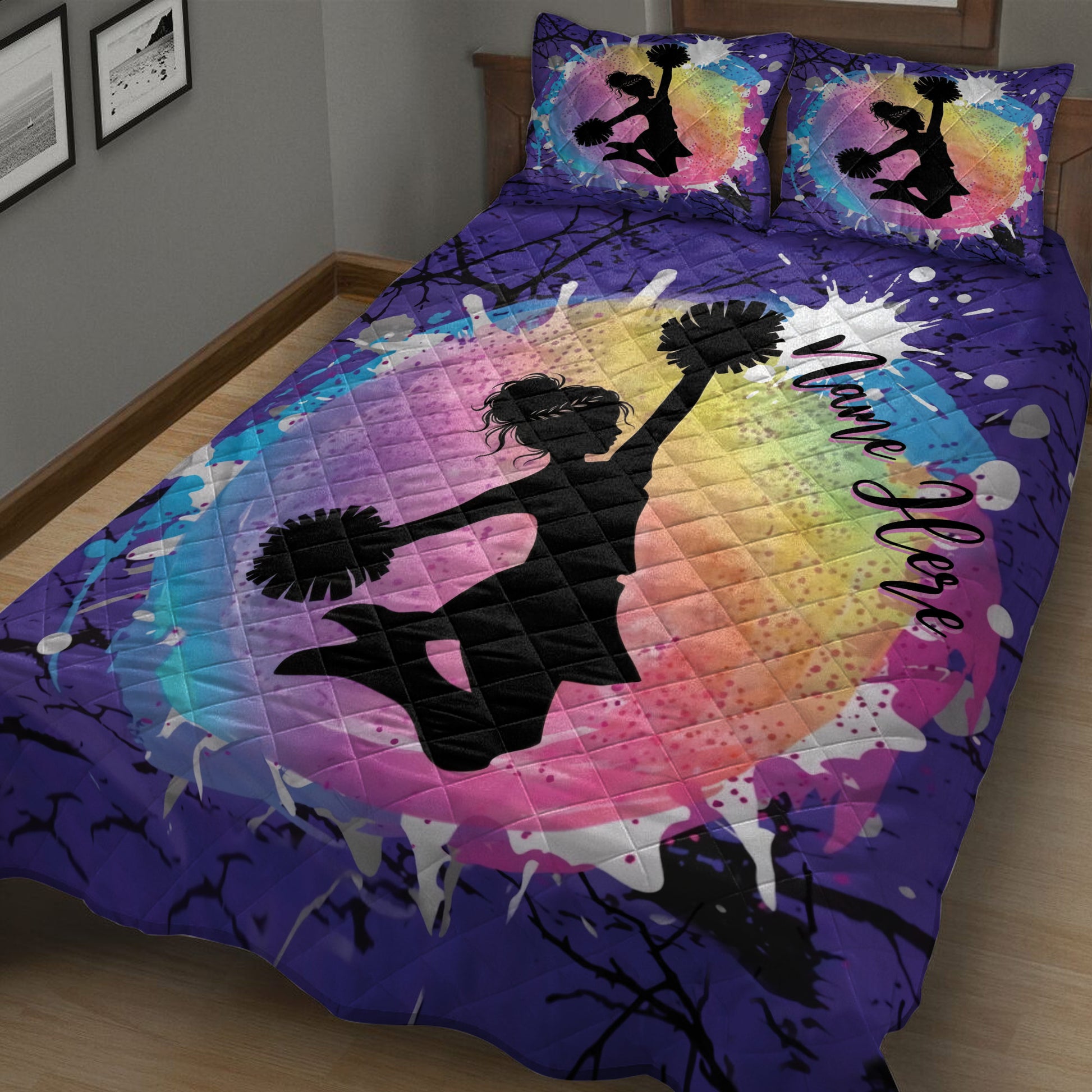 Purple cheerleading quilt featuring a jumping cheerleader silhouette and rainbow paint-splash design