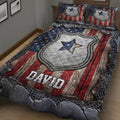 Close view of police quilt blanket with large badge artwork, stars, distressed stripes, and dark border