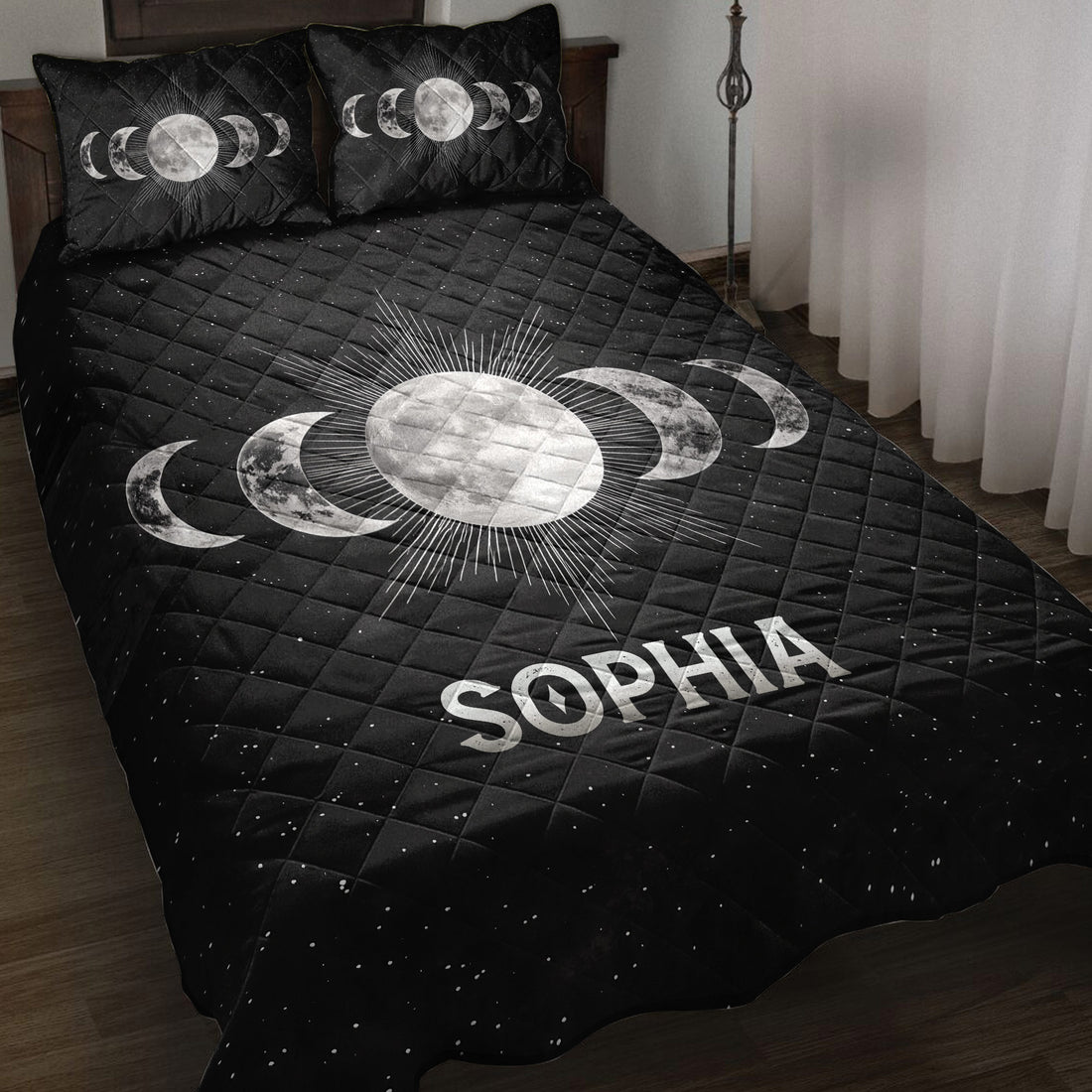 Black Wicca quilt blanket with moon phase artwork and radiant full moon displayed on a bedroom bed