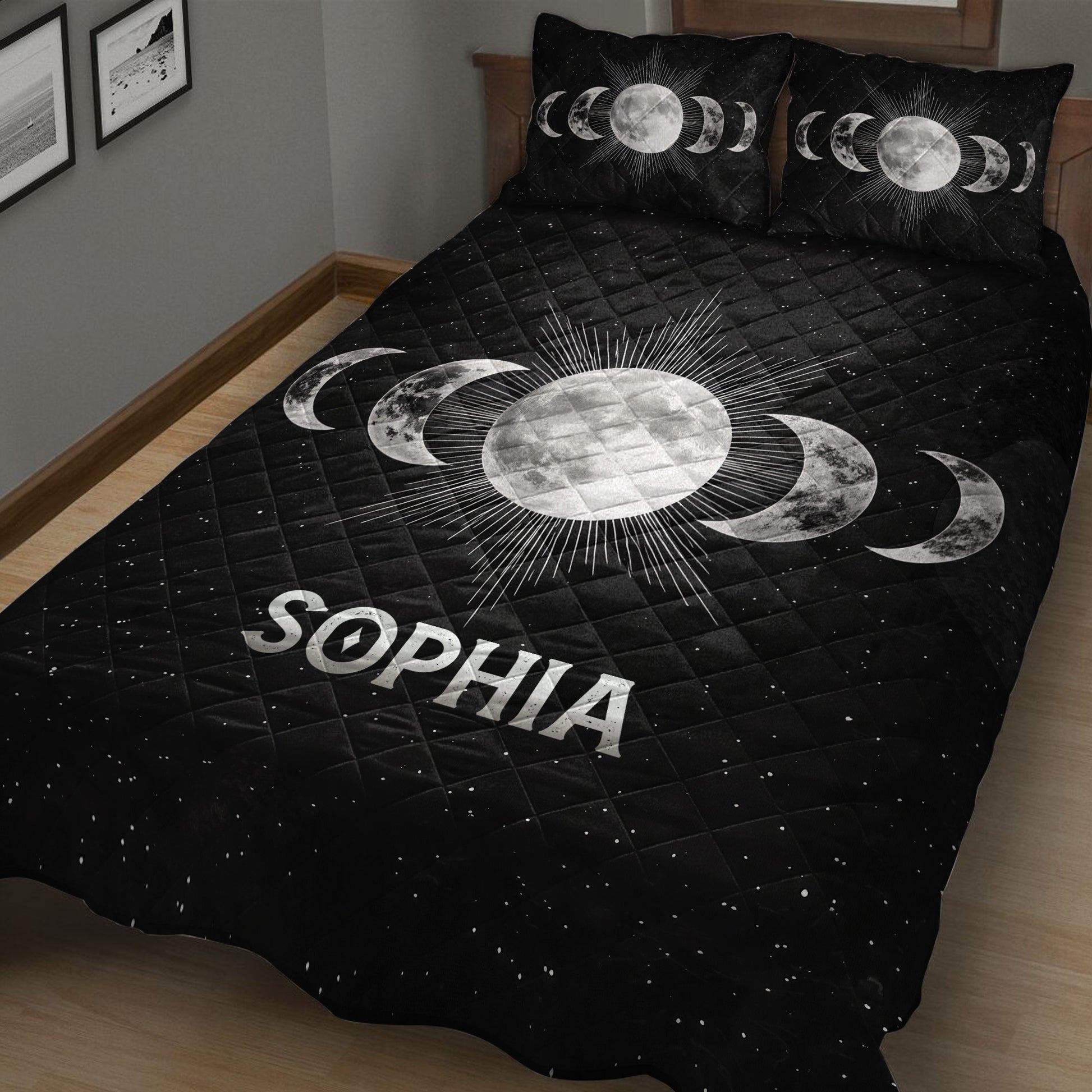 Angled view of a black Wicca quilt blanket with radiant moon and lunar phase design
