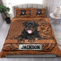 Rottweiler quilt bedding styled in a bright bedroom with matching dog artwork across the bed