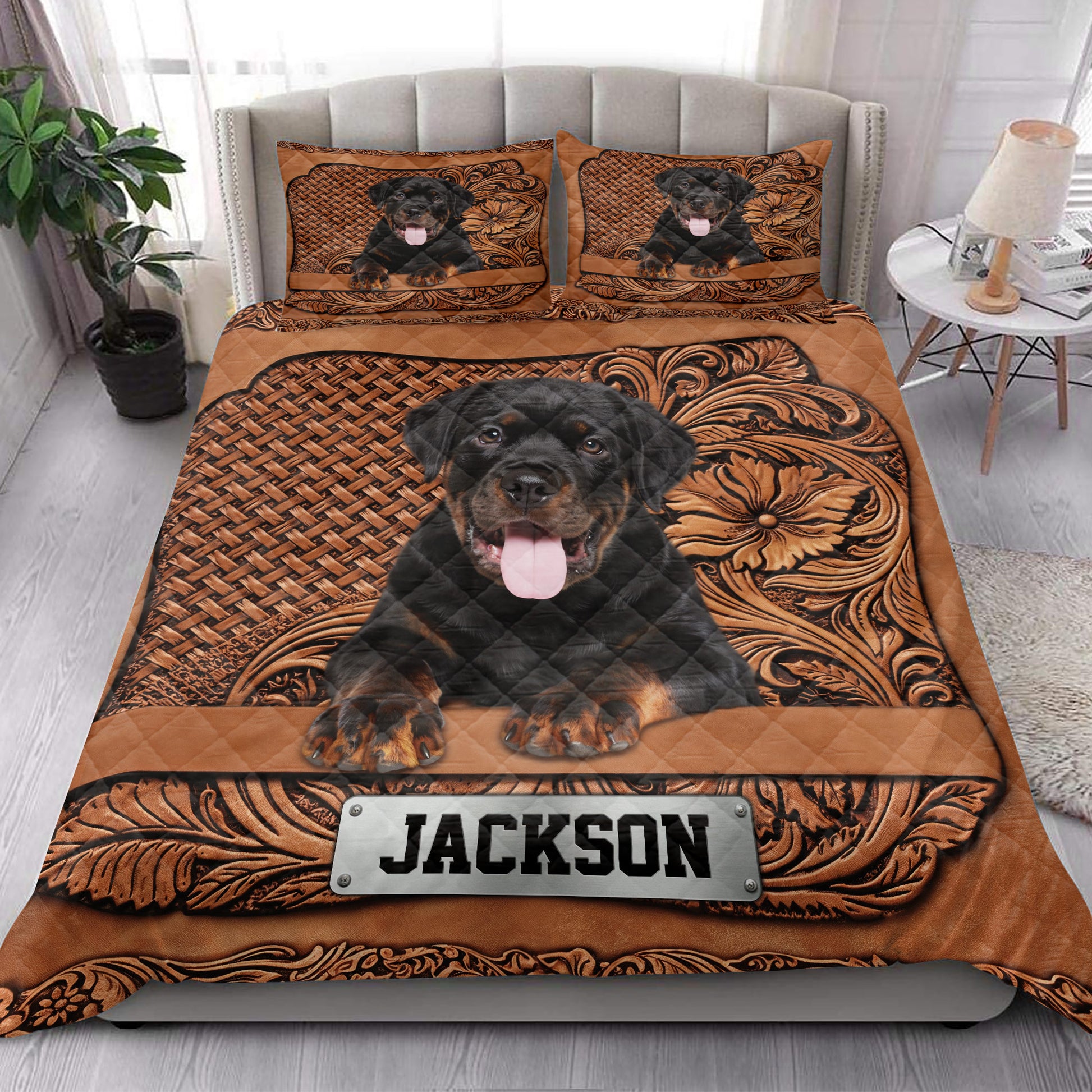 Rottweiler quilt bedding styled in a bright bedroom with matching dog artwork across the bed