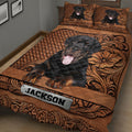 Close bedroom view of a Rottweiler quilt blanket with ornate brown patterns and dog artwork