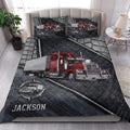 Trucking quilt bedding styled in a bedroom with red semi-truck artwork and dark gray geometric details