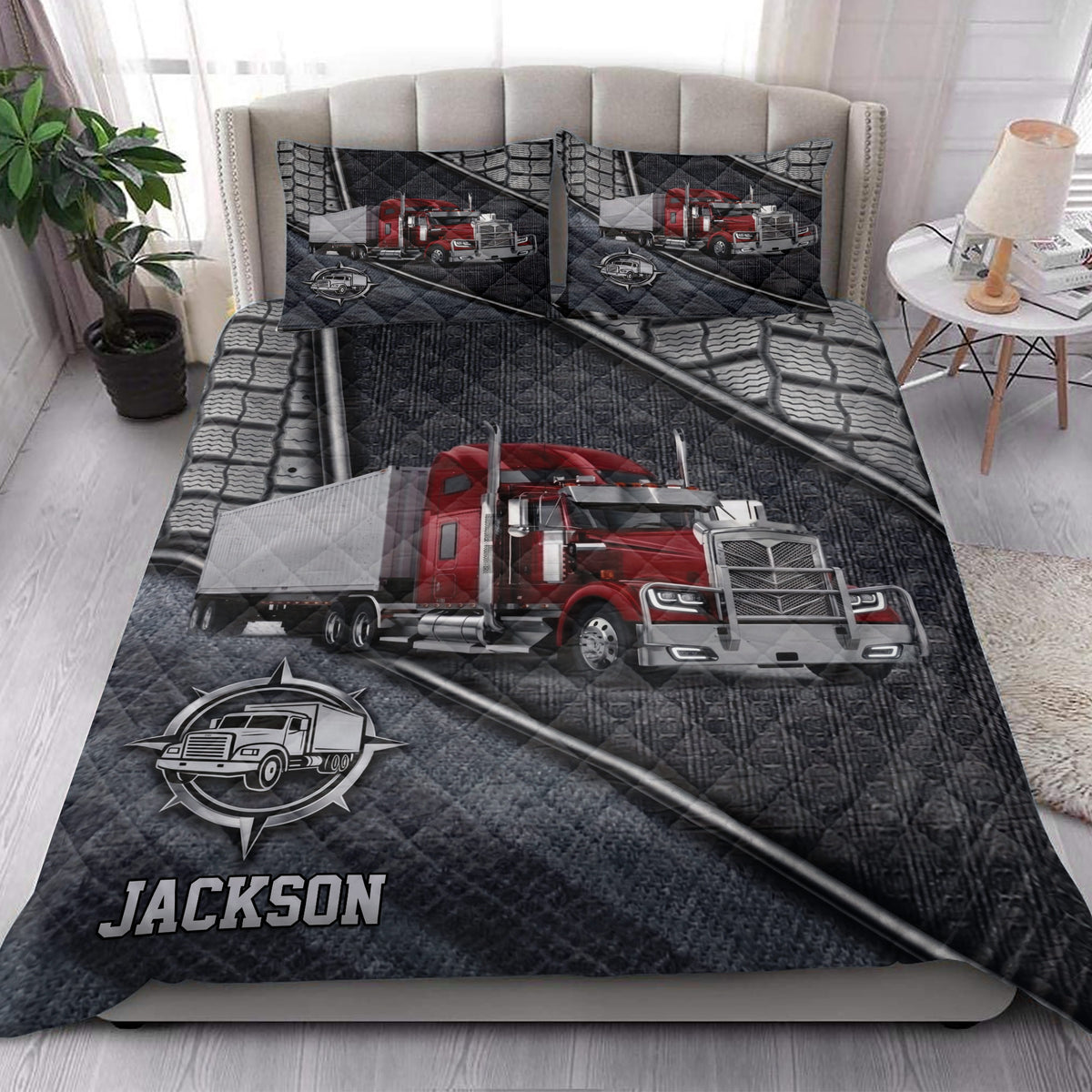 Trucking quilt bedding styled in a bedroom with red semi-truck artwork and dark gray geometric details