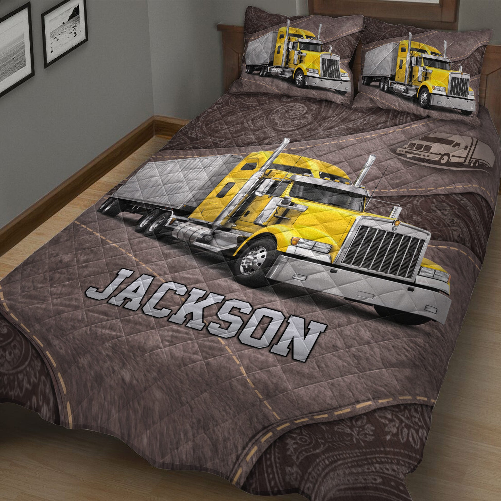 Close bedroom view of a trucker quilt blanket featuring a large yellow semi-truck and highway design