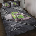 Trucker quilt blanket displayed on a bed with vivid green semi-truck artwork and coordinating pillow designs