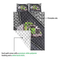 Close view of a trucker quilt blanket showing the printed semi-truck side and quilted white reverse