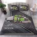 Trucker quilt blanket styled in a bright bedroom with large green semi-truck artwork across the bed